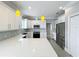 Spacious kitchen features stainless steel appliances, white cabinets, gray subway tile backsplash, and quartz counters at 731 Guernsey St, Orlando, FL 32804