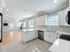 Bright kitchen with white cabinetry, stainless steel appliances, quartz countertops, and an open floor plan at 731 Guernsey St, Orlando, FL 32804