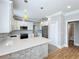 Updated kitchen with stainless appliances, gray subway tile backsplash, quartz countertops and white and stone cabinets at 731 Guernsey St, Orlando, FL 32804