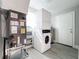 Efficient laundry room with a stacked washer and dryer unit, and easy access to utilities at 731 Guernsey St, Orlando, FL 32804