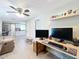 Open-concept living room with modern decor, a ceiling fan, and a glimpse into the bright kitchen at 731 Guernsey St, Orlando, FL 32804