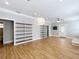 Open concept living room with hardwood floors, updated lighting, and built-in shelving at 731 Guernsey St, Orlando, FL 32804