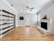 Hardwood floors throughout this updated living room with fireplace and built in shelving at 731 Guernsey St, Orlando, FL 32804