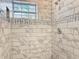 Walk-in shower featuring floor-to-ceiling marble tile and decorative trim work at 731 Guernsey St, Orlando, FL 32804