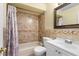 Bathroom featuring a tiled shower and tub combo, toilet, and modern white vanity at 7616 Southwick St, Orlando, FL 32818