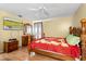 Bedroom with wooden furnishings, laminate flooring and ceiling fan at 7616 Southwick St, Orlando, FL 32818