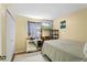 Simple bedroom featuring a bed, closet, dresser, and TV mounted on the wall at 7616 Southwick St, Orlando, FL 32818