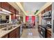 Modern kitchen with granite countertops, stainless steel appliances, and an open layout to the dining area, ideal for entertaining at 7616 Southwick St, Orlando, FL 32818