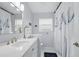 Well-lit bathroom features white cabinetry, updated fixtures, and a decorative shower curtain at 811 Wayne Ave, Altamonte Springs, FL 32701