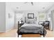 Light and airy bedroom with a metal bed frame, light hardwood floors, and bright natural light at 811 Wayne Ave, Altamonte Springs, FL 32701
