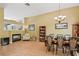 Bright dining room with hardwood floors, a decorative chandelier, and an open view to the living room with fireplace at 811 Wayne Ave, Altamonte Springs, FL 32701