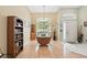 Bright dining area with hardwood floors, built-in shelving, and a large window at 811 Wayne Ave, Altamonte Springs, FL 32701