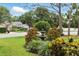 Landscaped front yard with a decorative fountain, adding charm and character to the property at 811 Wayne Ave, Altamonte Springs, FL 32701