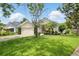 Charming single-Gathering home featuring a manicured lawn, mature trees, and a spacious two-car garage at 811 Wayne Ave, Altamonte Springs, FL 32701