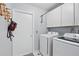 Functional laundry room includes washer, dryer, and storage cabinets at 811 Wayne Ave, Altamonte Springs, FL 32701