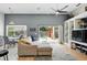 Bright living room with hardwood floors, a ceiling fan, and sliding glass doors leading to the pool at 811 Wayne Ave, Altamonte Springs, FL 32701
