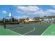 Community basketball court featuring green surface, white lines, and hoops, great for sports and recreation at 8941 Bismarck Palm Rd, Kissimmee, FL 34747