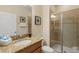 Well-appointed bathroom with a granite vanity, framed mirror, and glass-enclosed shower at 8941 Bismarck Palm Rd, Kissimmee, FL 34747