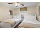 Bedroom with two beds, ceiling fan, window, and neutral decor at 8941 Bismarck Palm Rd, Kissimmee, FL 34747