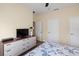 Comfortable bedroom with a ceiling fan and dresser with ample storage at 8941 Bismarck Palm Rd, Kissimmee, FL 34747