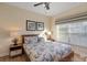 Serene bedroom with a ceiling fan, natural light, and charming decor at 8941 Bismarck Palm Rd, Kissimmee, FL 34747