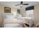 Bright bedroom with two beds, ceiling fan, window, and neutral decor at 8941 Bismarck Palm Rd, Kissimmee, FL 34747