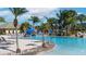 Stunning community pool with mature palm trees and a slide feature at 8941 Bismarck Palm Rd, Kissimmee, FL 34747