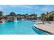 Gorgeous community pool with lush landscaping, fountains, and waterfall features at 8941 Bismarck Palm Rd, Kissimmee, FL 34747