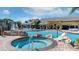 Beautiful community pool, waterfall feature, hot tub, and ample seating area at 8941 Bismarck Palm Rd, Kissimmee, FL 34747