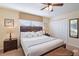 Comfortable bedroom featuring a ceiling fan, window, closet, and bedside tables at 8941 Bismarck Palm Rd, Kissimmee, FL 34747