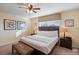 Comfortable bedroom featuring a ceiling fan, window, and bedside tables at 8941 Bismarck Palm Rd, Kissimmee, FL 34747
