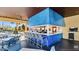 Community pool bar featuring modern blue decor, a long counter, and ample seating for residents and guests at 8941 Bismarck Palm Rd, Kissimmee, FL 34747