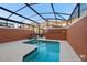 A serene in-ground screened-in pool with lounge chairs and a private backyard at 8941 Bismarck Palm Rd, Kissimmee, FL 34747