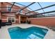 Private screened-in swimming pool with outdoor seating and a spacious patio area at 8941 Bismarck Palm Rd, Kissimmee, FL 34747