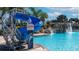 Fun community pool featuring a thrilling blue water slide at 8941 Bismarck Palm Rd, Kissimmee, FL 34747