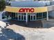 Exterior view of an AMC movie theater, showcasing a modern facade and inviting entrance at 9169 Harris Hawk Dr, Leesburg, FL 34788