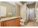 Bathroom featuring granite countertops, wood cabinets, toilet, and access to an outdoor area at 10161 Sandy Marsh Ln, Orlando, FL 32832