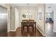 Cozy dining area with dark wood table, seating for four, and industrial-chic light fixtures at 10161 Sandy Marsh Ln, Orlando, FL 32832