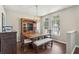 Elegant dining room with hardwood floors, display cabinet and a large window bringing in natural light at 10161 Sandy Marsh Ln, Orlando, FL 32832