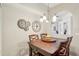 Cozy dining area with dark wood table, seating for four, and industrial-chic light fixtures at 10161 Sandy Marsh Ln, Orlando, FL 32832
