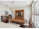 Elegant dining room with hardwood floors, display cabinet and a large window bringing in natural light at 10161 Sandy Marsh Ln, Orlando, FL 32832