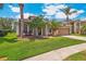 Beautiful home with a two-car garage, freshly manicured lawn, mature landscaping and bench at 10161 Sandy Marsh Ln, Orlando, FL 32832