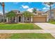 Well-maintained home with a two-car garage, beautiful landscaping, and a freshly manicured lawn at 10161 Sandy Marsh Ln, Orlando, FL 32832