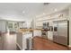 Bright kitchen with granite countertops, stainless steel appliances and a view of the living area at 10161 Sandy Marsh Ln, Orlando, FL 32832