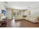 Spacious living room with hardwood floors, a sectional sofa, and sliding glass doors to the patio at 10161 Sandy Marsh Ln, Orlando, FL 32832