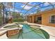 Sparkling pool and spa in a screened enclosure, surrounded by lush landscaping and a brick patio at 10161 Sandy Marsh Ln, Orlando, FL 32832