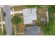 An aerial view shows the home, yard, a fire pit, and an outbuilding at 1094 Henry Balch Dr, Orlando, FL 32810