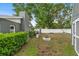 Spacious backyard includes a stone fire pit, shed, and maintained hedges at 1094 Henry Balch Dr, Orlando, FL 32810