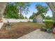 Spacious backyard featuring a storage shed, garden beds, and a charming hammock at 1094 Henry Balch Dr, Orlando, FL 32810