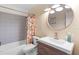 Bathroom featuring modern vanity, toilet, patterned tile backsplash and floors, and shower with orange curtains at 1094 Henry Balch Dr, Orlando, FL 32810